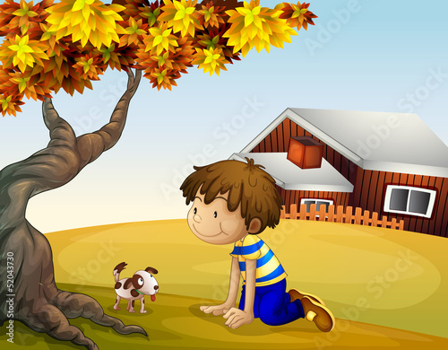 A boy and his puppy under the tree