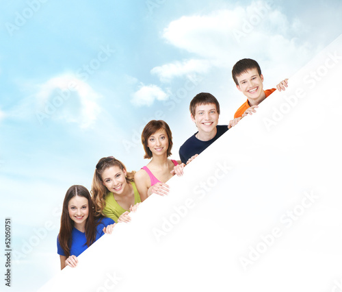 Group of teenagers with a giant, blank, white billboard