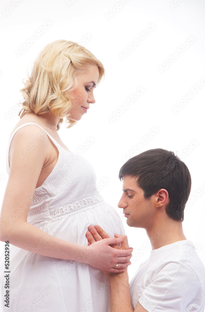 Young attractive couple: pregnant mother and happy father isolat Young attractive couple: pregnant mother and happy father isolat