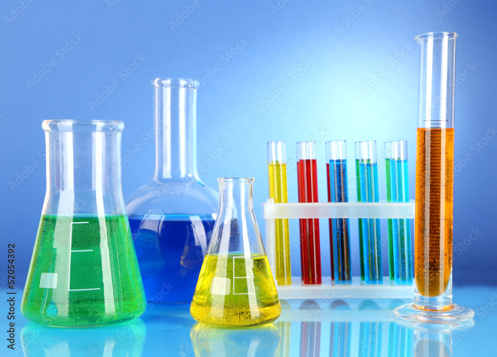 Test tubes with colorful liquids on blue background Test tubes with colorful liquids on blue background