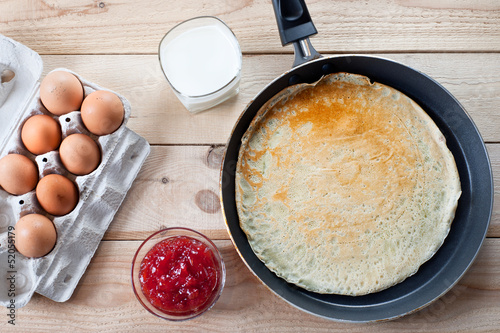 Pancake with eggs and jam on breakfast