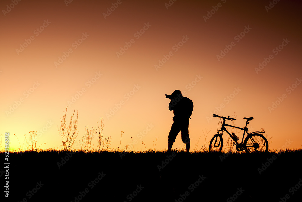 silhouette of a cyclist with sunset background silhouette of a cyclist with sunset background