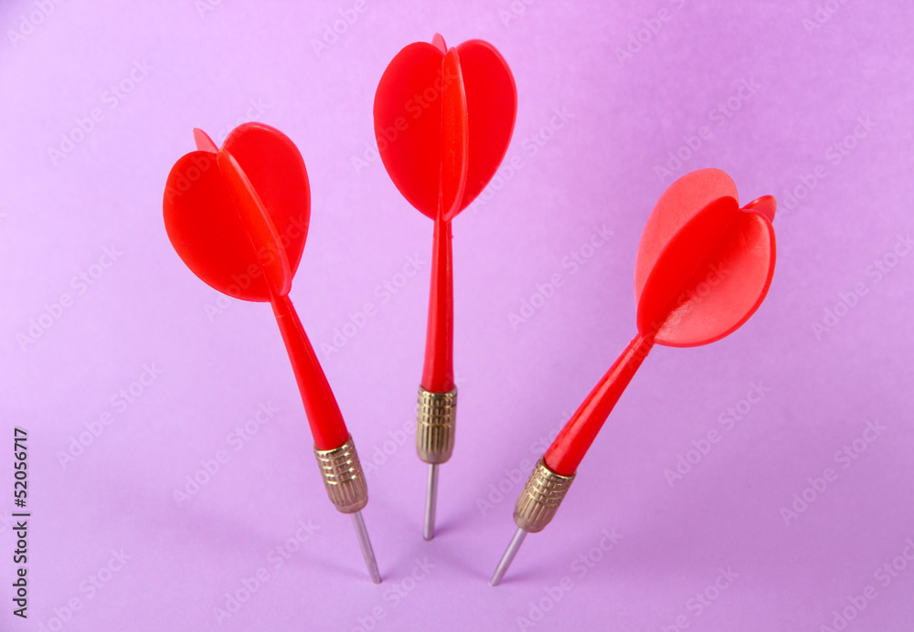Darts on purple background Darts on purple background