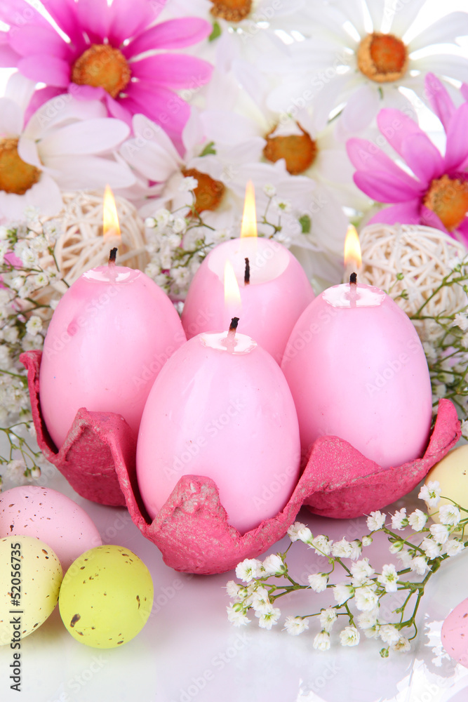 Easter candles with flowers close up Easter candles with flowers close up