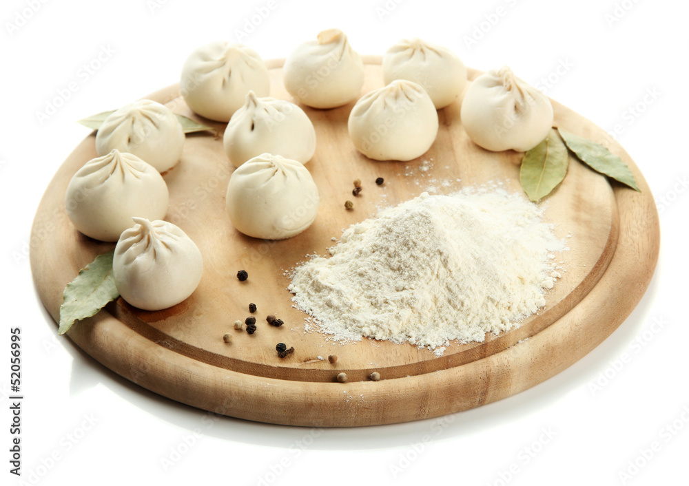 Raw khinkali on wooden desk, isolated on white Raw khinkali on wooden desk, isolated on white