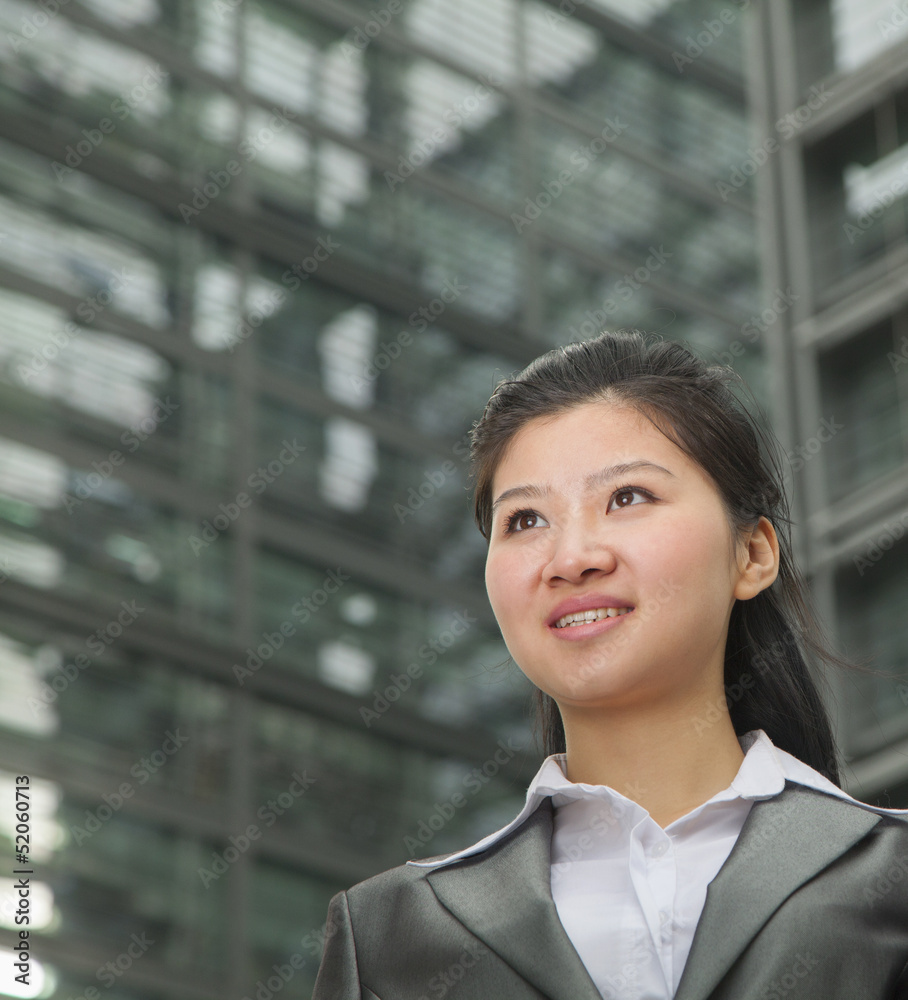 Portrait of young businesswoman outdoors among skyscrapers Portrait of young businesswoman outdoors among skyscrapers