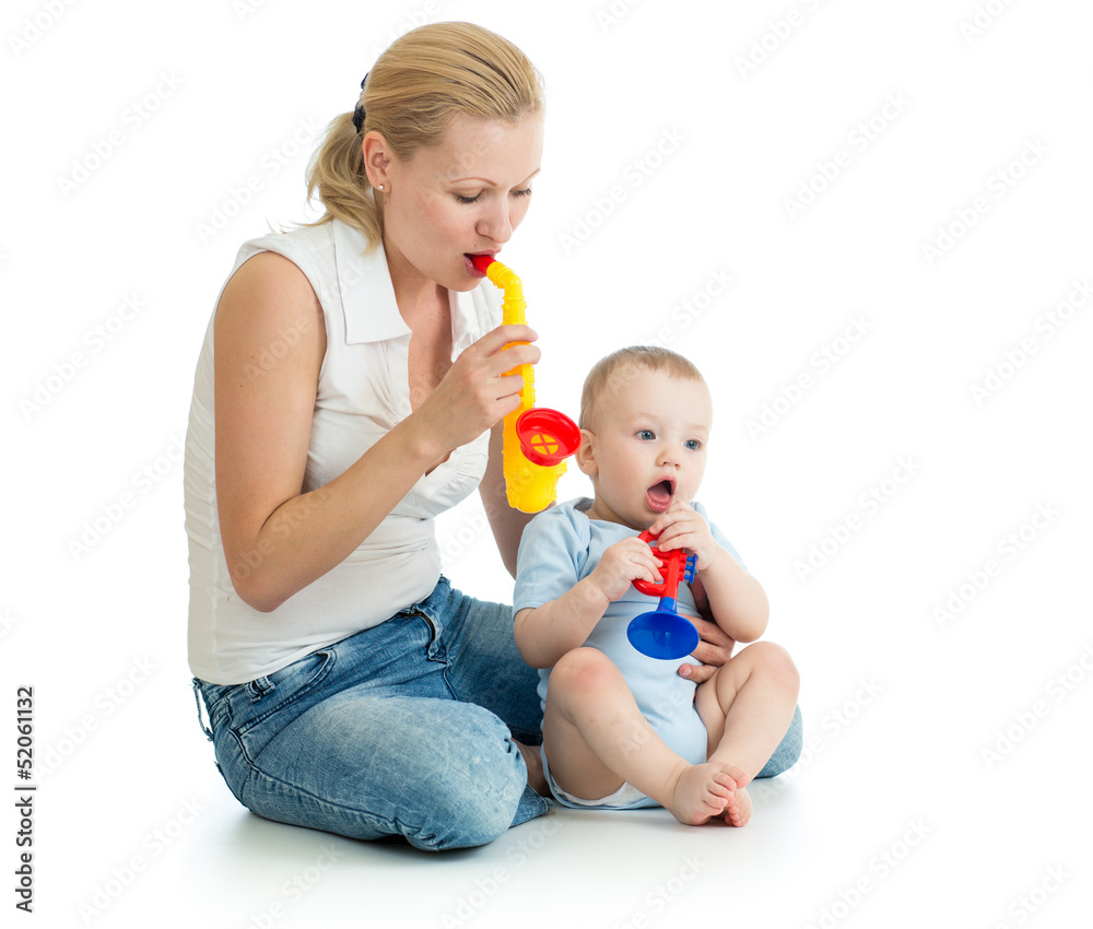 Mother and baby boy having fun with musical toys Mother and baby boy having fun with musical toys