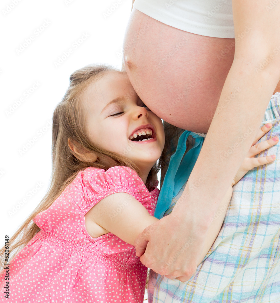 happy kid girl hugging pregnant mother's belly happy kid girl hugging pregnant mother's belly