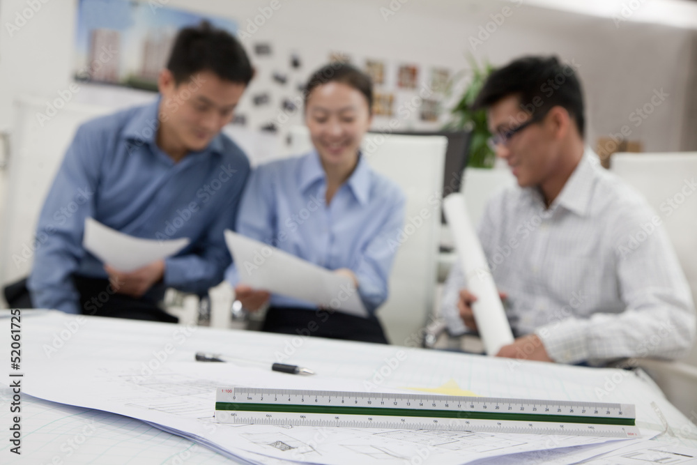 Coworkers discussing project in the office Coworkers discussing project in the office
