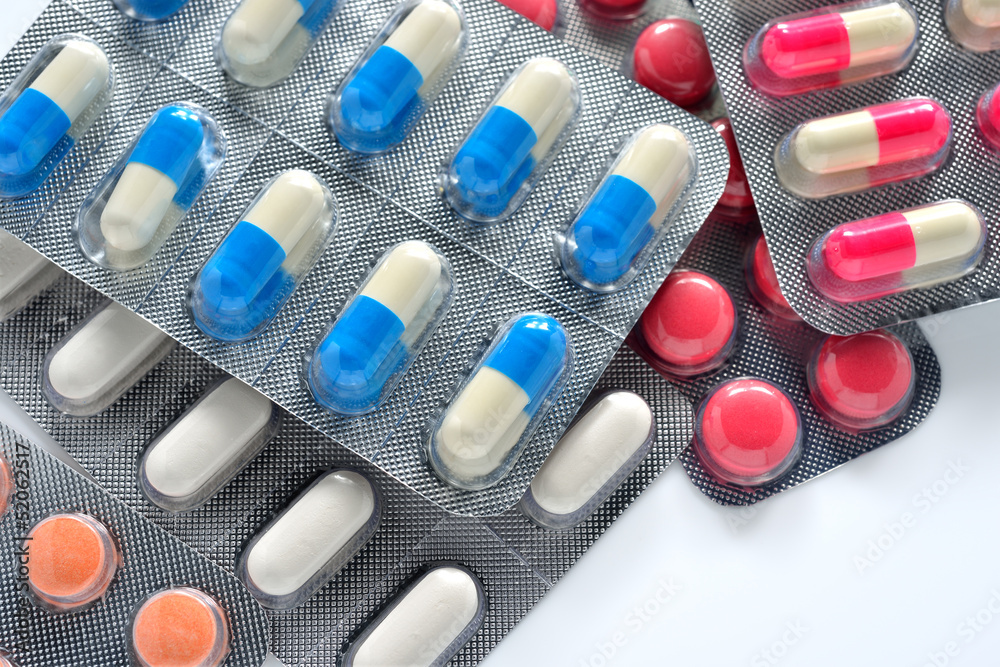 colorful capsules and pills closeup on white colorful capsules and pills closeup on white