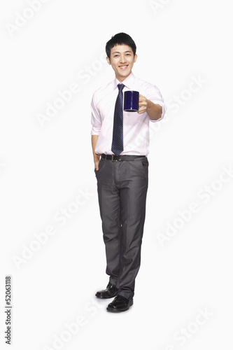 Businessman smiling with mug © xixinxing