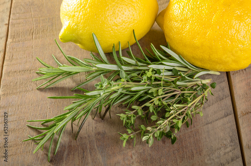 Lemons and herbs on a wooden table