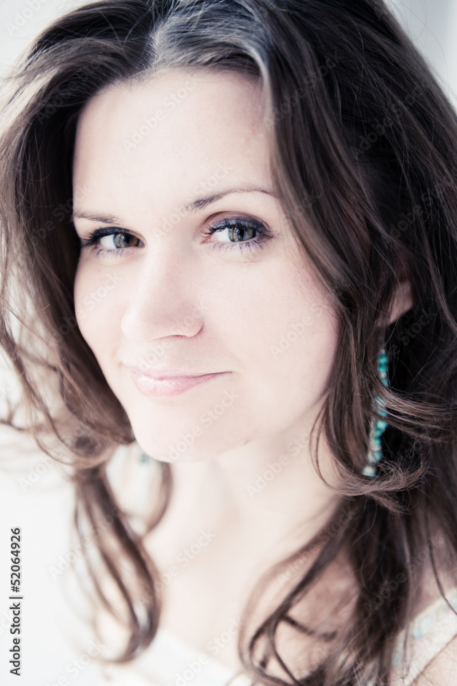 Naklejka premium Portrait of beautiful young happy smiling woman with long curly