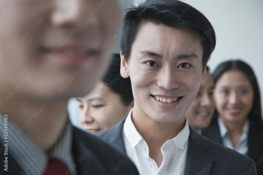 Businessman with co-workers in office portrait Businessman with co-workers in office portrait