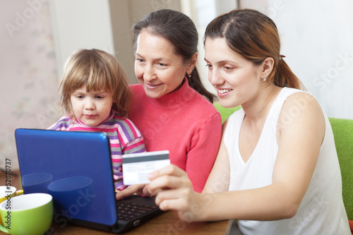 Happy family paying by credit card in internet store