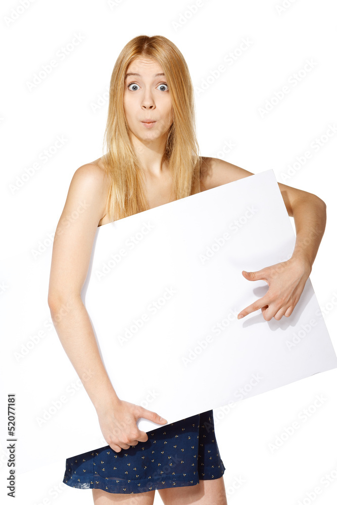 Surprised girl holding white board under hand and pointing at it Surprised girl holding white board under hand and pointing at it
