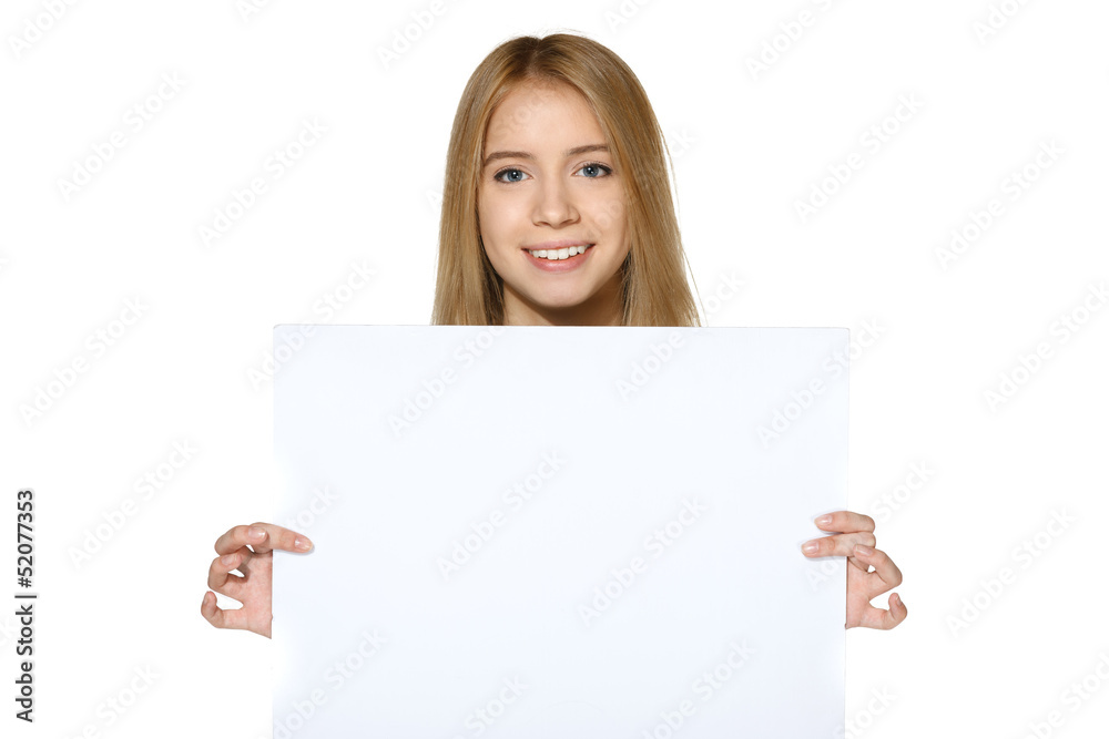 Smiling teen girl holding blank white paper Smiling teen girl holding blank white paper