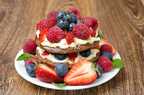 Pancake cake with whipped cream and fresh berries horizontal