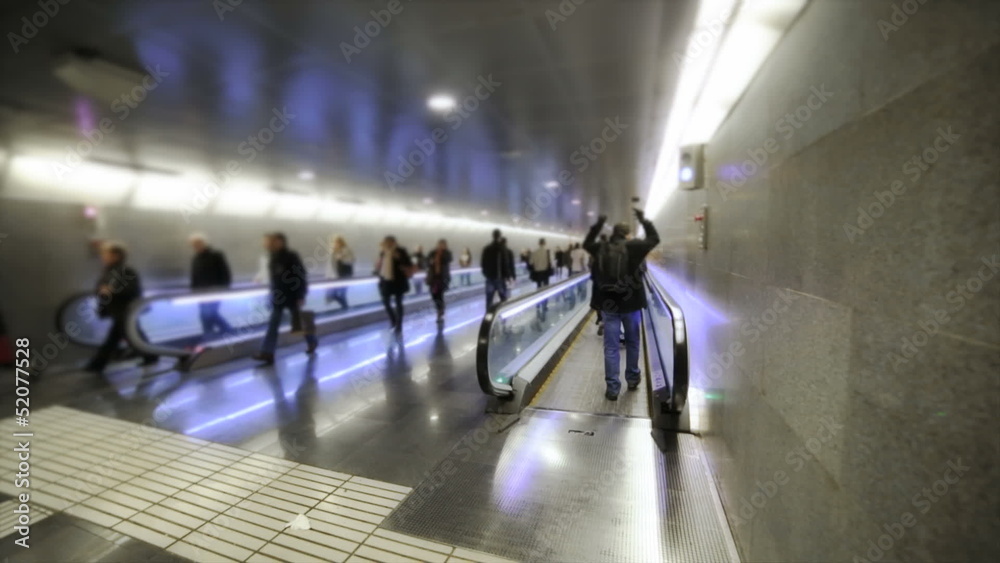 Persons moving in underground corridor. Slow motion Persons moving in underground corridor. Slow motion