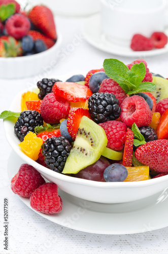 Fototapeta Naklejka Na Ścianę i Meble -  salad of fresh fruit and berries in a white bowl