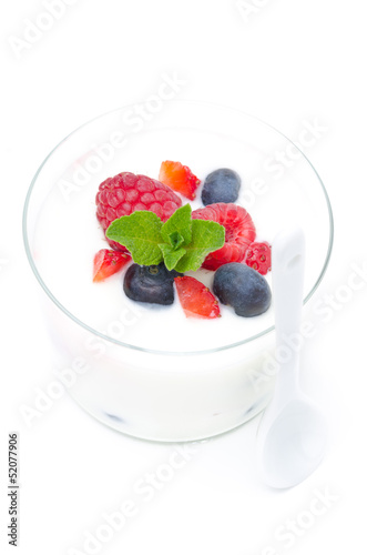 yogurt with different fresh berries and mint in a glass beaker