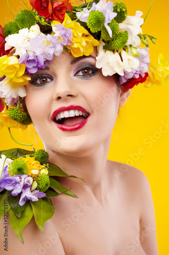 The attractive girl  front portrait  on a head a flower wreath