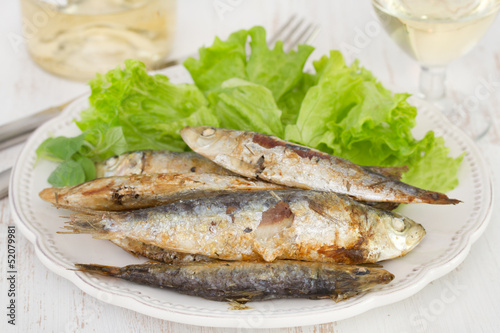 fried fish with salad on the plate