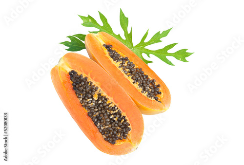 Ripe papaya with seeds and green leaf