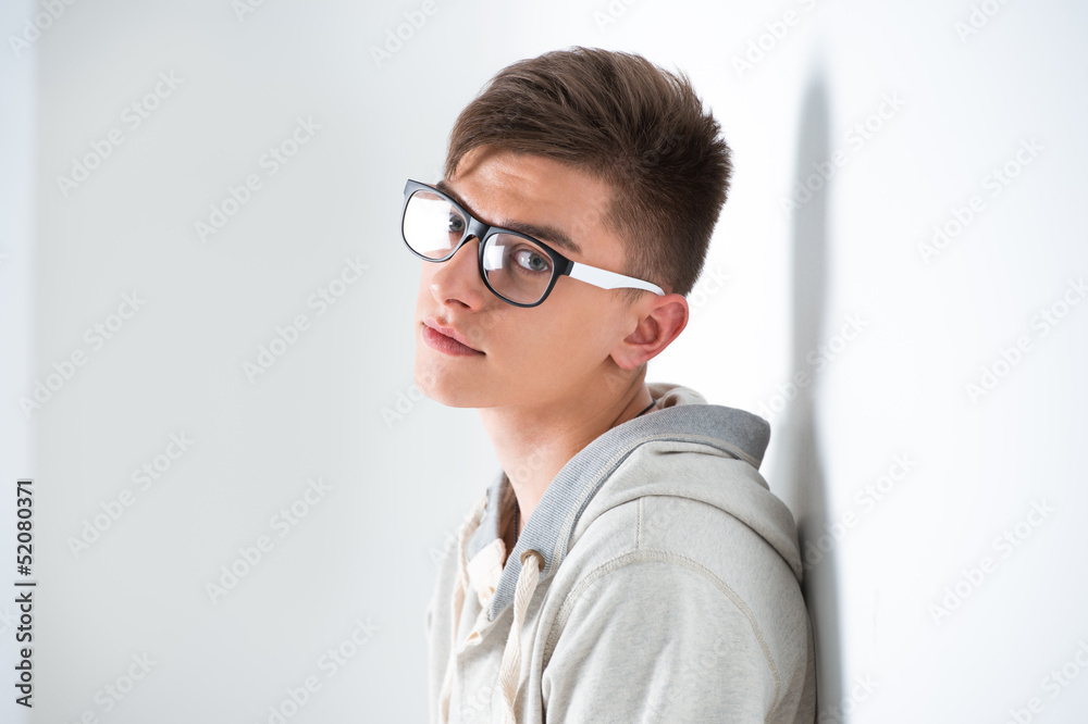 Portrait of young fashionable man leaning on white wall and wear Portrait of young fashionable man leaning on white wall and wear
