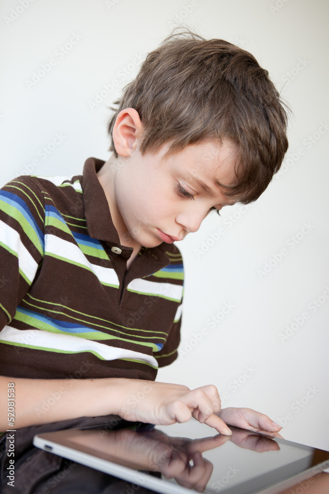 Child playing on a tablet PC Child playing on a tablet PC