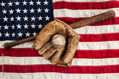 Vintage baseball, bat and glove on American flag photo