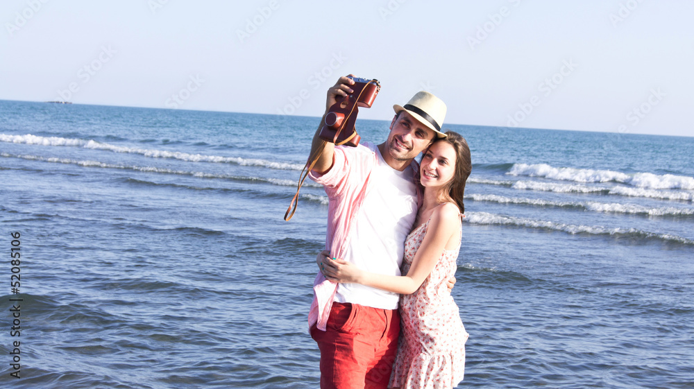 A cheerful couple fooling around on the beach A cheerful couple fooling around on the beach