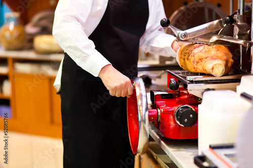 Canvas Print Butcher slicing ham