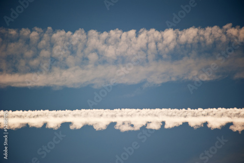 Horizondal aircraft trails in the sky © yellowpaul