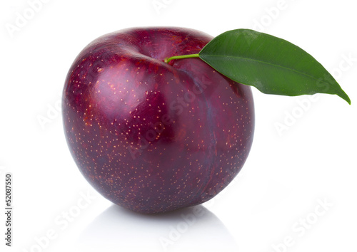 Ripe purple plum fruit with green leaves isolated