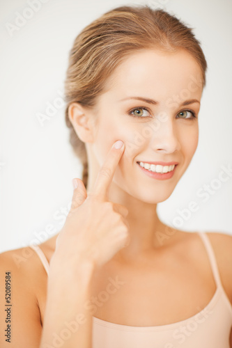 woman pointing at her cheek