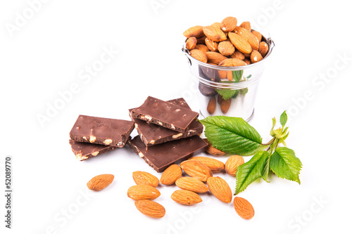 Almonds in a backet with pieces of chocolate with nuts