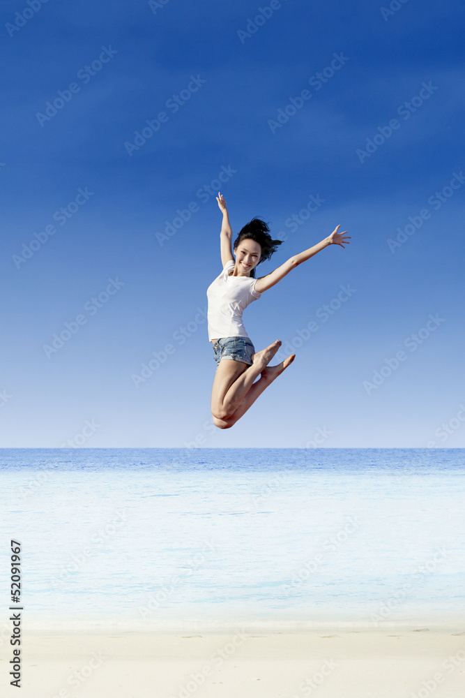 Asian girl jump at white sand beach Asian girl jump at white sand beach