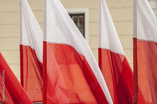 Polish flags on a background of wall.