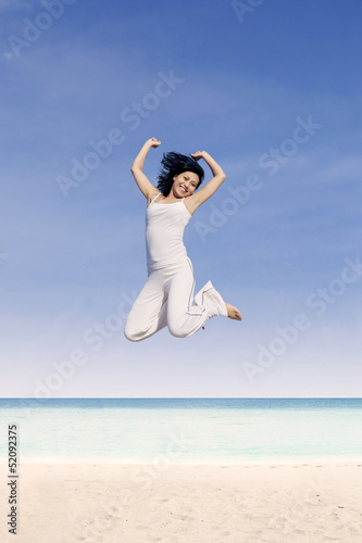 Beautiful woman jump at beach