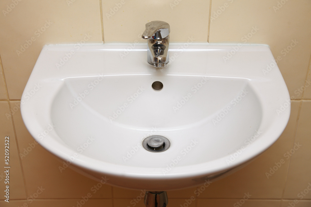 White sink and tap in the bathroom White sink and tap in the bathroom