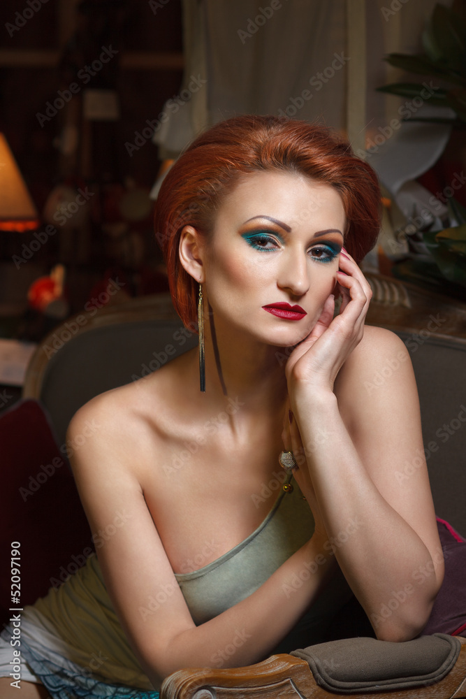 Portrait of attractive woman. Retro styled, french furniture.