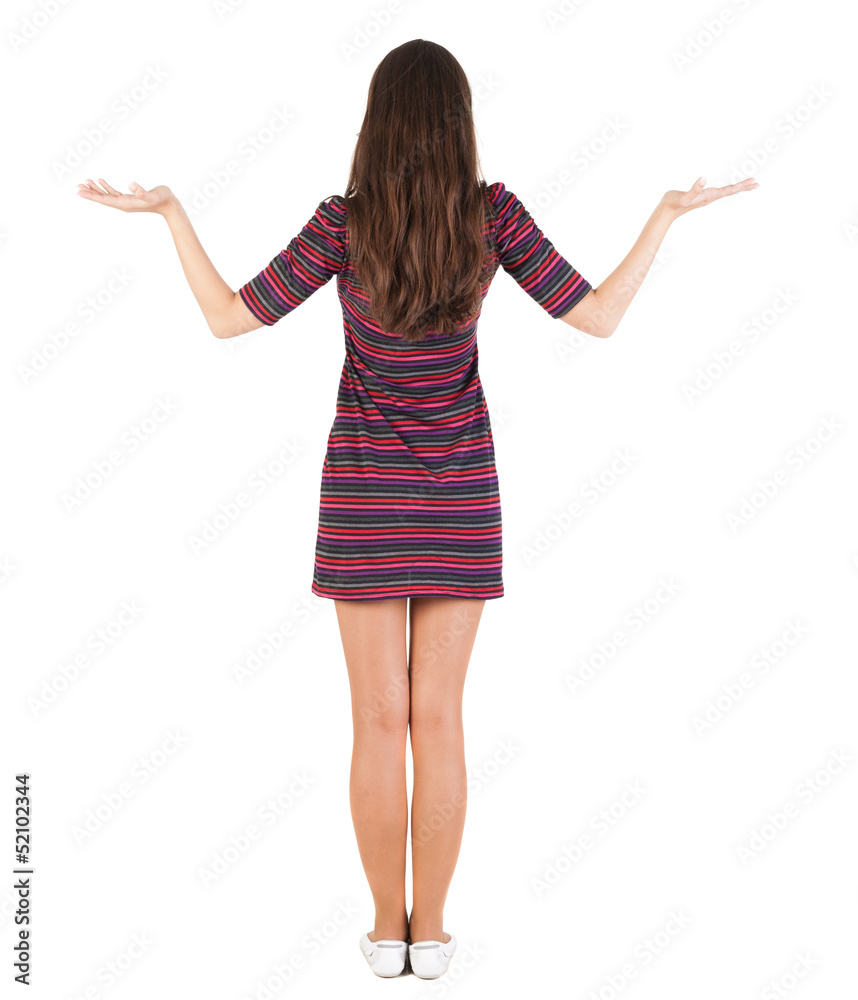 Back view of Beautiful woman in dress looking at wall and Holds Back view of Beautiful woman in dress looking at wall and Holds