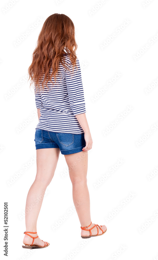 back view of walking young beautiful redhead woman. back view of walking young beautiful redhead woman.