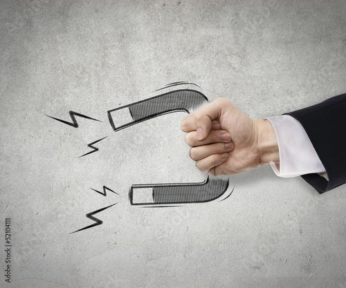 Businessman use magnet to attract