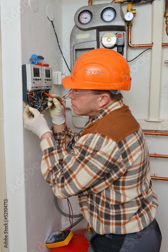 Electrician at work with his instrument of measurement.