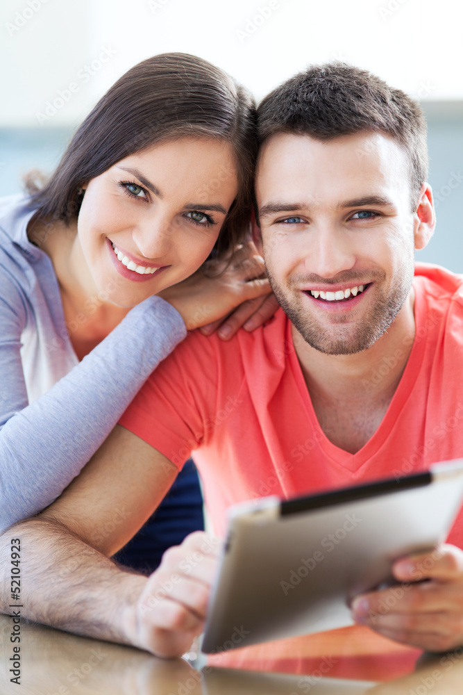 Happy couple with digital tablet