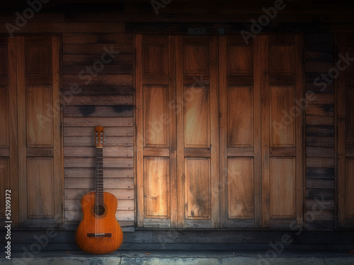 old classic guitar on wood wall