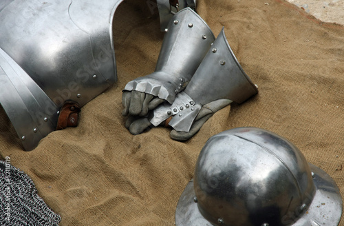 gloves and metal armor with a helmet during the medieval spectac photo