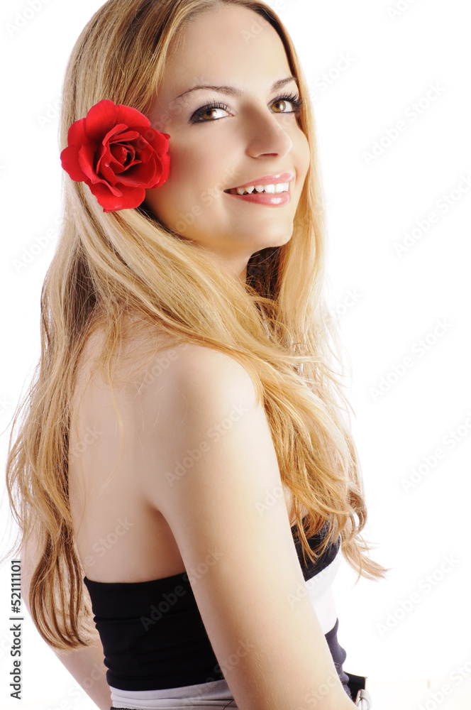Beautiful young woman with red rose in her hair